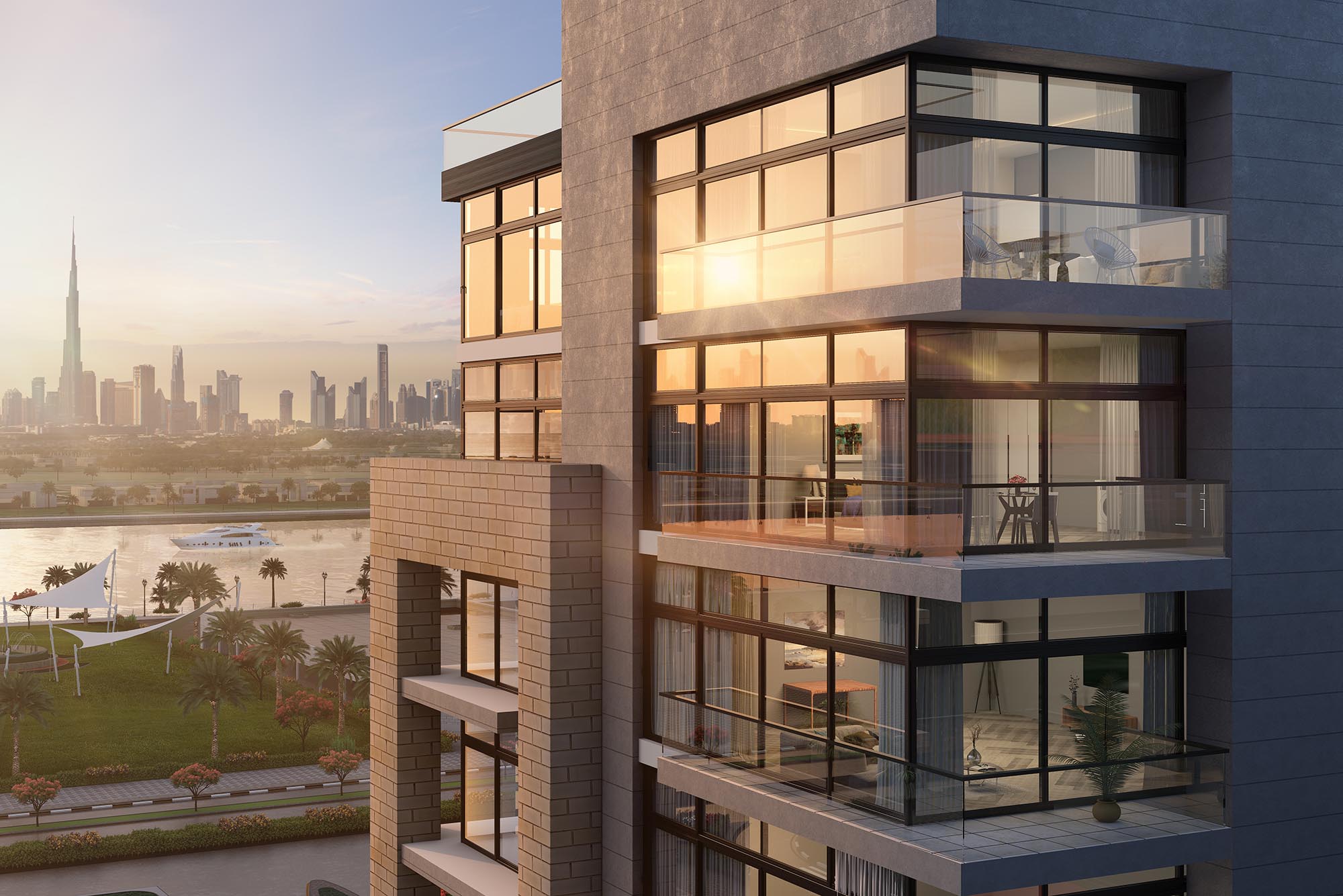 Close-up of Azizi Riviera building balconies with canal views and Burj Khalifa at sunset